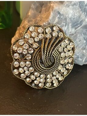 Vintage Kramer of New York Flower rhinestone brooch with gold-tone swirl design